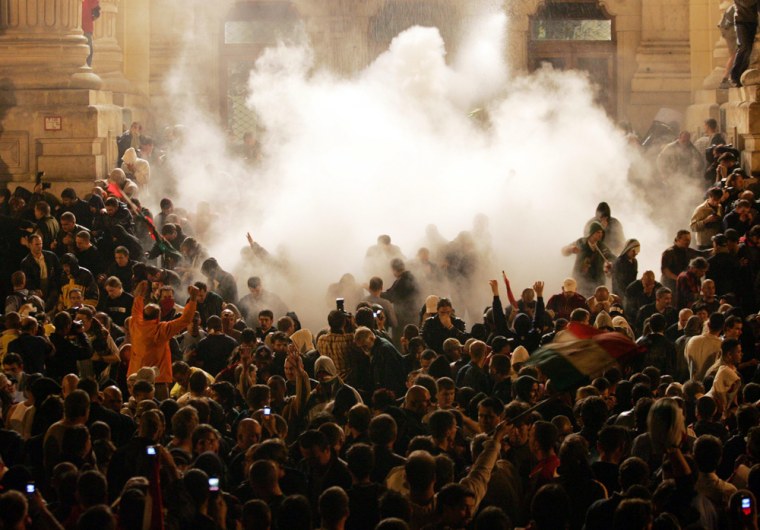 Hungarian riot police use teargas against anti-government protesters front of the state television building in Budapest