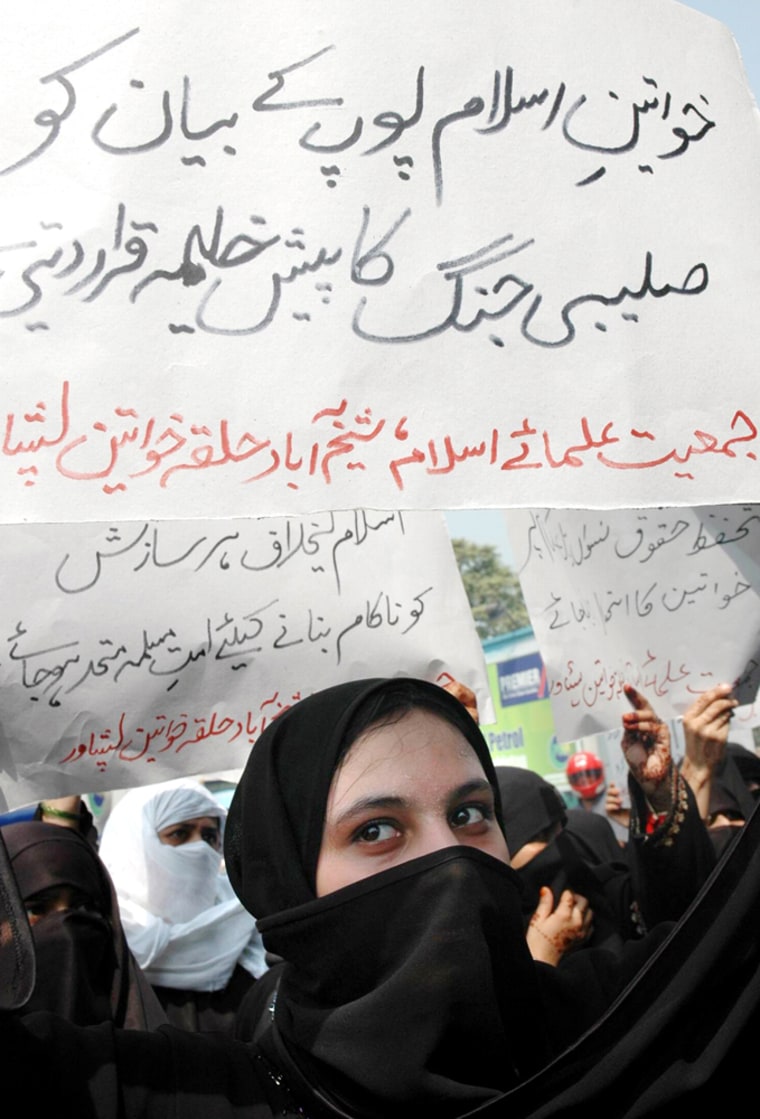 A supporter of a religious party participates in a rally against Pope Benedict on Monday in Peshawar, Pakistan. The placard reads "Muslim women consider pope's remarks as prelude of crusade." 