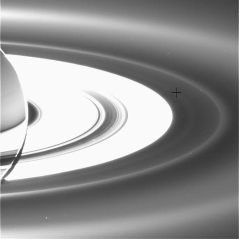 A newly detected ring of Saturn lies outside the main rings and inside the outer G and E rings. A black cross has been added to this picture to mark the location of the faint, diffuse ring.