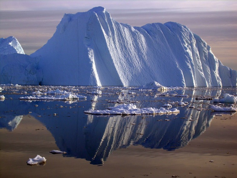 An iceberg calved from a glacier floats in the Jacobshavn fjord in southwest Greenland, where temperatures have risen in recent years and ice sheet loss has accelerated.