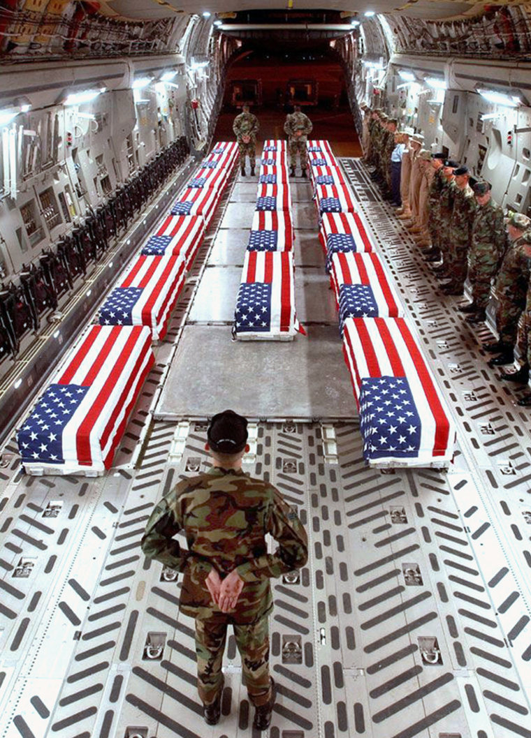Flag-draped coffins of U.S. war casualties are seen aboard a cargo plane in Dover, Del., in a recent but undated photo made available by the U.S. Defense Department. 