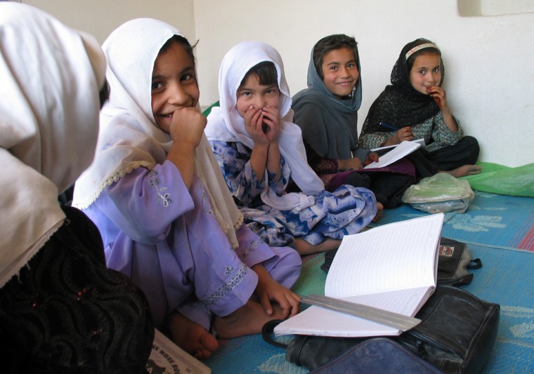Girls gather for a drawing class Friday at a home school in Sheikhabad, Afghanistan, where they are studying because it is not safe for them to attend public school.