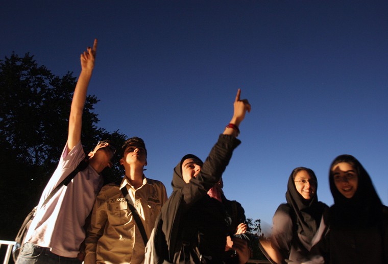 Iranian youths point at the international space station in the skies above Zaferanieh Observatory in north Tehran at dawn on Saturday. The skywatchers gathered to watch for the spacecraft carrying Iranian-born space passenger Anousheh Ansari.