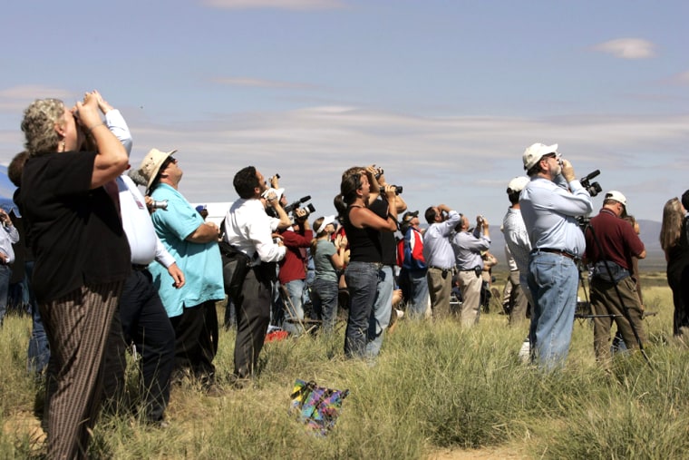 Spectators watch the launch of SpaceLoft XL from a desert launch range near Truth or Consequences