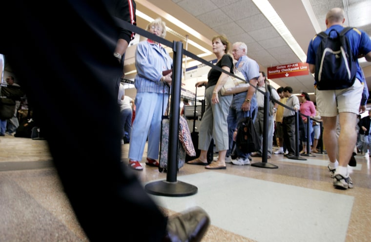 Airline passengers wait in a long line at a security checkpoint at San Jose International Airport in San Jose, Calif., Aug. 10. 