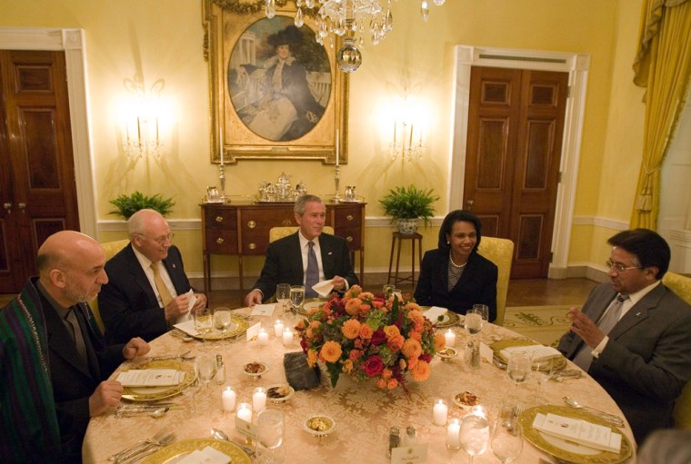 President Bush sits with Vice President Dick Cheney and Secretary of State Condoleezza Rice as they host a working dinner with Afghan President Hamid Karzai, left, and Pakistani President Pervez Musharraf, right, on Wednesday at the White House.