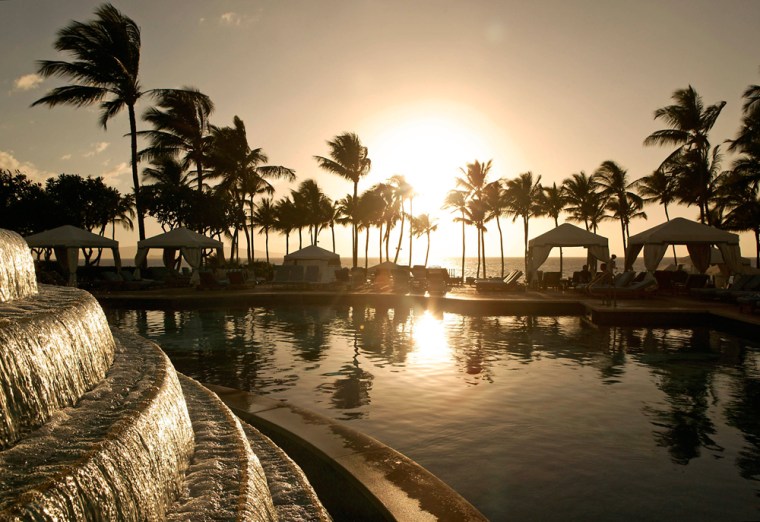 A view of the sun setting poolside from the Grand Wailea Resort, Feb. 6, in Wailea, Maui, Hawaii.