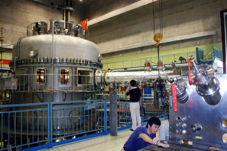 A scientist debugs the Experimental Advanced Superconducting Tokamak, or EAST, at the Institute of Plasma Physics of the Chinese Academy of Sciences in Hefei on Thursday. Scientists say they carried out China's first successful test of an experimental fusion reactor.