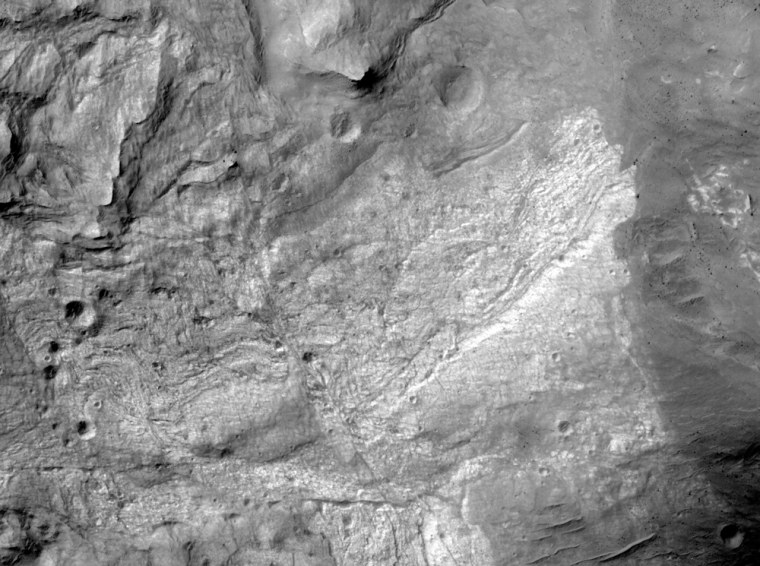 The first image taken by the HiRISE camera during the Mars Reconnaissance Orbiter's full-scale scientific mission reveals a portion of the floor of Ius Chasma, one branch of the giant Valles Marineris system of canyons on Mars. The MRO spacecraft was about 174 miles (280 kilometers) above the Martian surface when this picture was taken.
