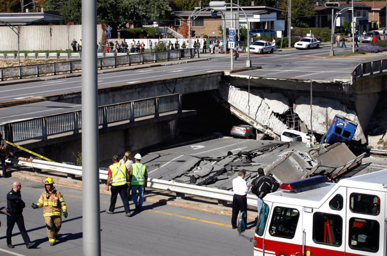 Rescue workers survey the site of an overpass in Laval, Quebec, on Saturday.