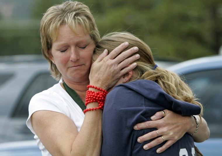 Woman hugs her daughter after they were reunited at Platte Canyon High School in Bailey Colorado