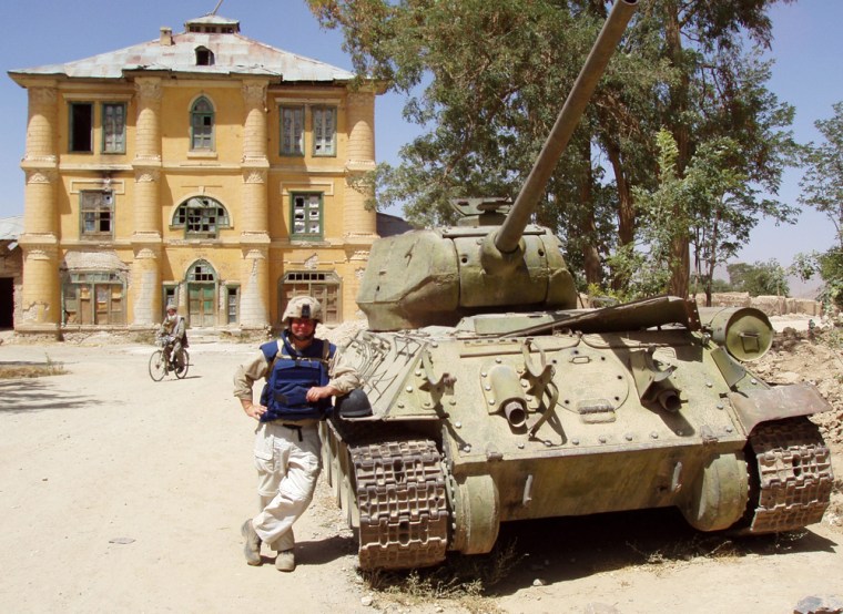 Correspondent Kerry Sanders stands next to an old Russian tank in Moqur, Afghanistan. A reminder of this country's last 30-years of war.