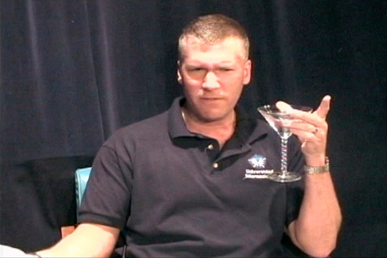 This image taken from video provided by WBBM-TV in Chicago shows Rich Mitchell, the superintendent of the Bremen High School District, holding a martini glass in a mock documentary he created and posted on the district's Web site.