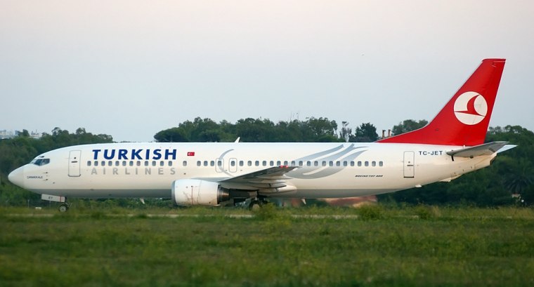 A hijacked Turkish Airlines plane sits on the runway at the Brindisi airport
