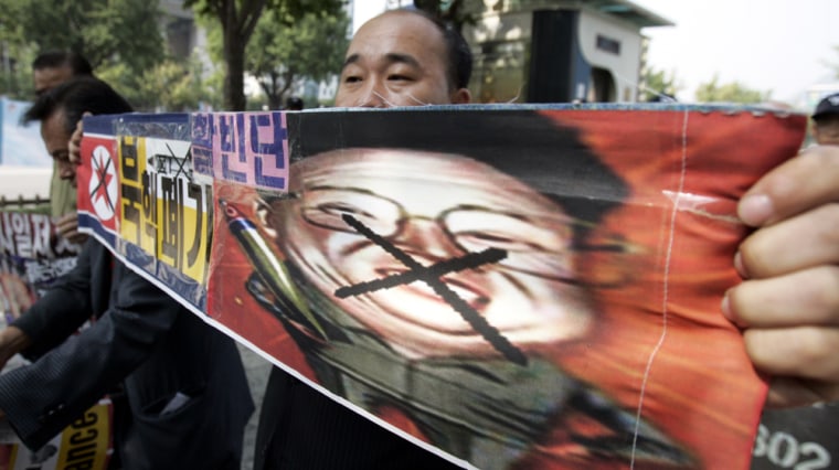 A South Korean protester holds a picture of North Korean leader Kim Jong Il, during an anti-North Korea rally in downtown Seoul on Wednesday. South Korean President Roh Moo-hyun called for a "cool-headed and stern" response to the North's threat to conduct a nuclear test.