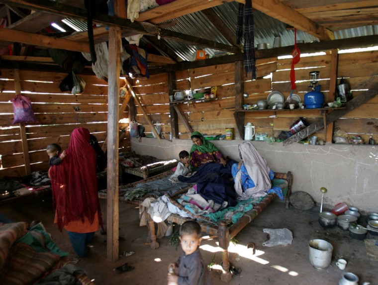 Earthquake survivors live in their shelter in Dubri Bandi, Pakistan, situated at edge of a massive landslide which killed about 1,800 people in October 2005.