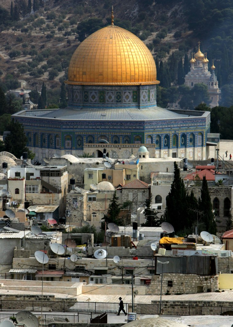 An Orthodox Jew passes the Dome of the Rock, one of Islam's shrines built on the Temple Mount, in Jerusalem's Old City on Sunday, the Jewish holiday of Sukkot, also known as the Feast of Tabernacles.