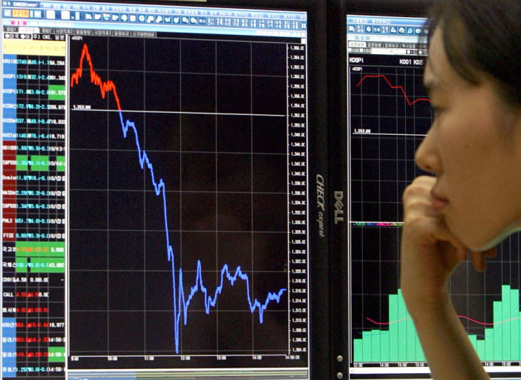 A South Korean woman checks a stocks ind