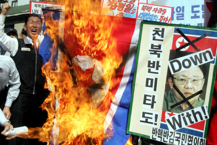 South Korean protesters burn a defaced North Korean flag during an anti--Pyongyang rally in Seoul on Tuesday.