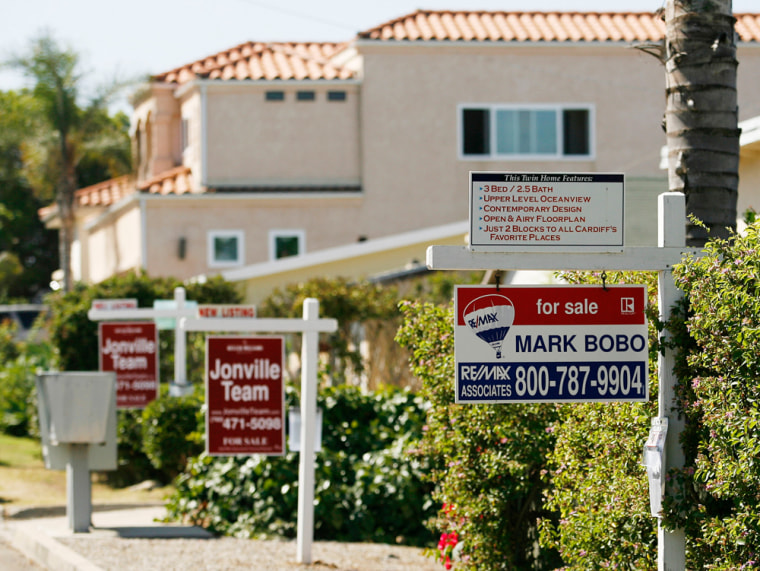 Real estate signs advertise the sale of three homes in a row in the San Diego, Calif. suburb of Encinitas earlier this year. Futures traders are betting San Diego home prices will fall by 8.2 percent this year.