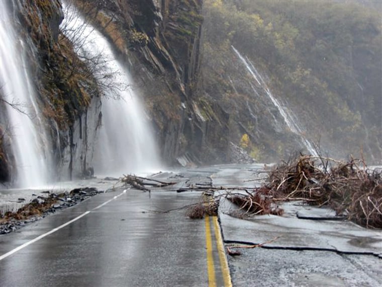 Water washes over the Richardson Highway north of Valdez, Alaska, on Tuesday. Floodwaters severely damaged a stretch of the highway, closing the road and blocking Valdez from the rest of Alaska.