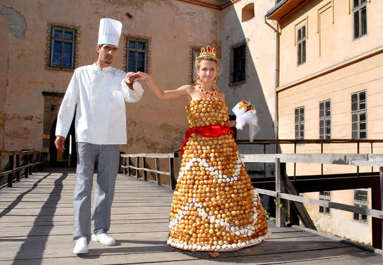 Baker Valentyn Shtefano and his bride Viktoriya show off her wedding gown, which Shtefano made out of flour, eggs, sugar and caramel, in the western Ukrainian city of Uzhhorod on Aug. 27.