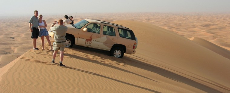 A South African tour guide at Al Maha takes photos of guests on a “dune bashing” drive in the Arabian Desert that surrounds the resort in Dubai.