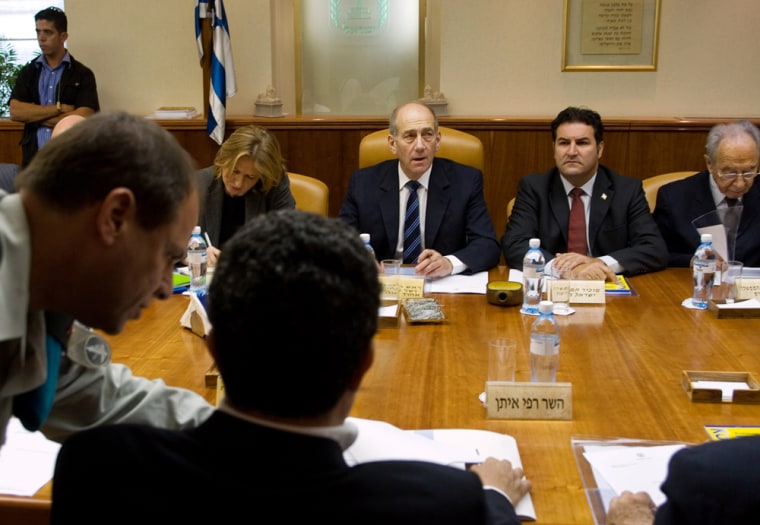 Israeli Prime Minister Ehud Olmert , center, Vice Premier Shimon Peres, right, Foreign Minister Tzipi Livni, left, and Cabinet Secretary Yisrael Maimon, are seen at the weekly cabinet meeting at his Jerusalem office, in this photo taken Sunday. 
