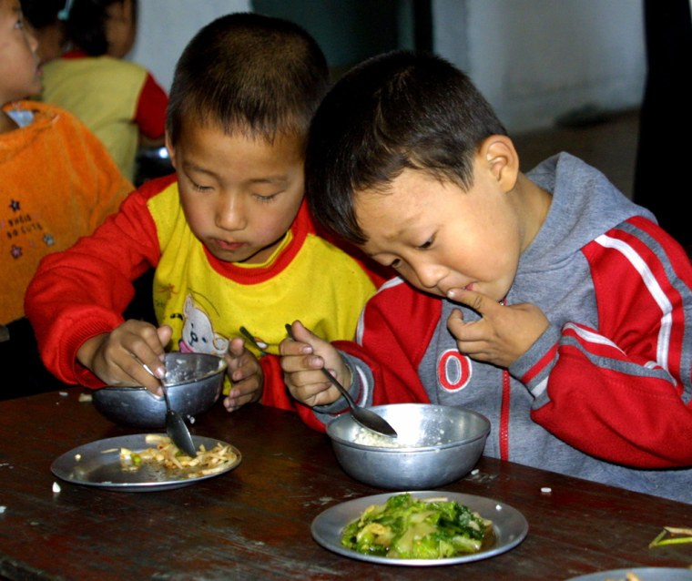 Children eat in kindergarten in the North Korean city of Hyangsan