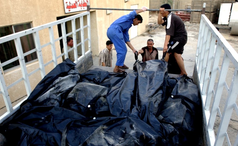 Hospital morgue workers unload bodies of people killed in recent sectarian violence in the town of Balad, Iraq on Saturday.