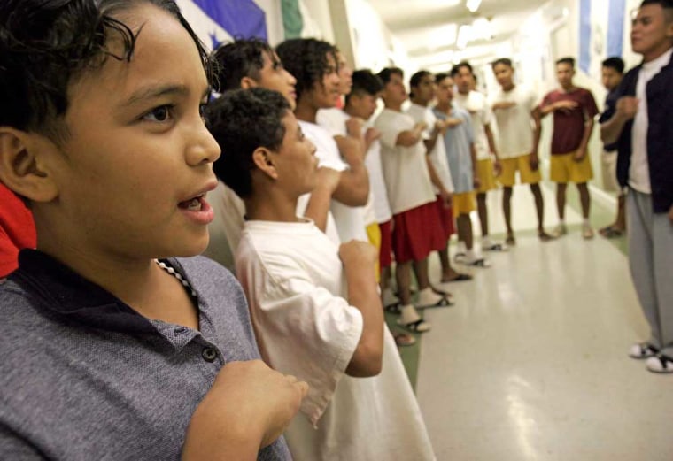 Twelve-year-old Marlon, left, joins other boys from Honduras to sing their national anthem on Honduras' Independence Day.