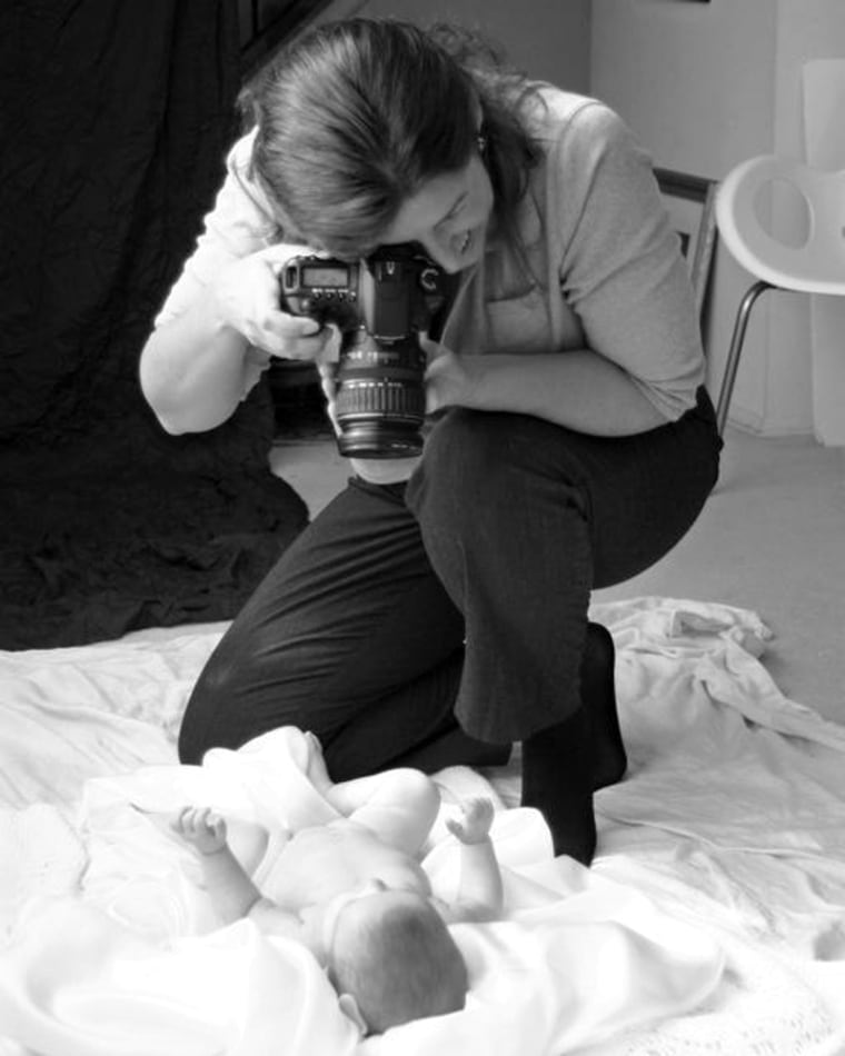 Photographer Hollis Healy takes a baby picture as part of a long-term contract to create a set of family photos.
