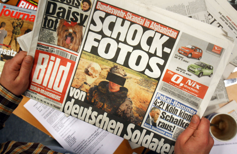 A journalist reads a copy of German tabl