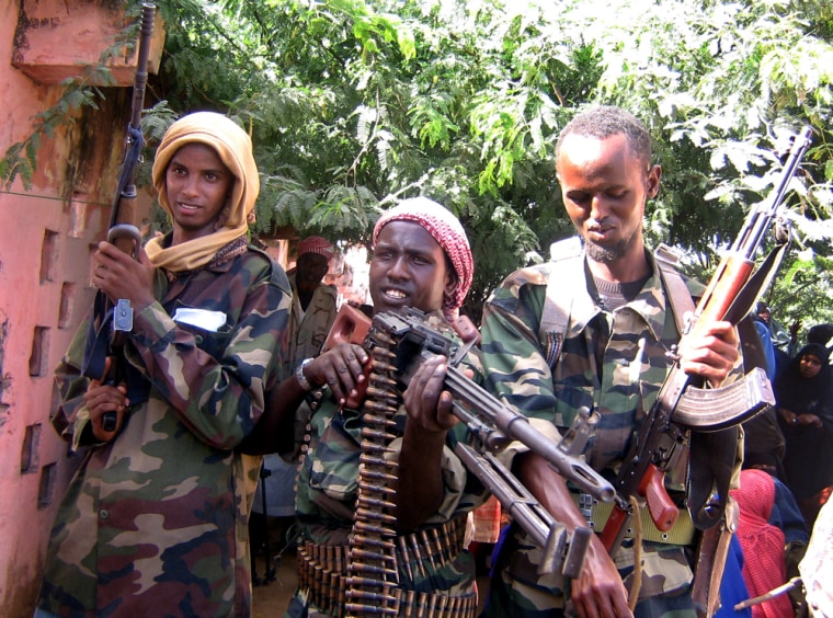 Members of the Islamic militia pose with their guns on Friday during an anti-Ethiopia rally in the Somali capital, Mogadishu. In more than 40 towns and villages across southern Somalia on Friday, thousands took to the streets after calls from Islamic leaders to protest Ethiopia's backing of the virtually powerless government. Some 15,000 turned out alone in the Somali capital, Mogadishu. 