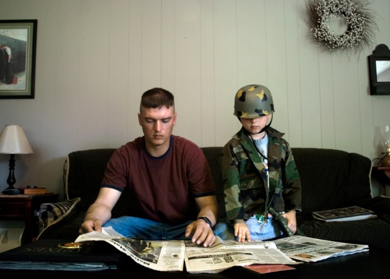 Sgt. Travis Brill reads the paper while his son Kaden, 6, wears military clothes like his father's. Iraq changed the men of Lima Company, 3rd Battalion, 25th Marines, guiding and afflicting them in ways many are struggling to understand. Lima took more casualties than any U.S. company in Iraq, losing 23 Marines killed in action.