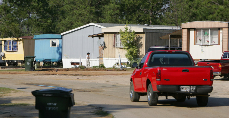 **  ADVANCE FOR WEEKEND NOV. 4-5 **FILE**A pickup truck drives through the Town & Country trailer park in Tifton, Ga., in this  March 6, 2006 file photo. Last fall, burglars broke into four mobile homes at the park and attacked and robbed Mexican immigrants there and at other trailer parks in the Tifton area, leaving six people dead. (AP Photo/Ric Feld)