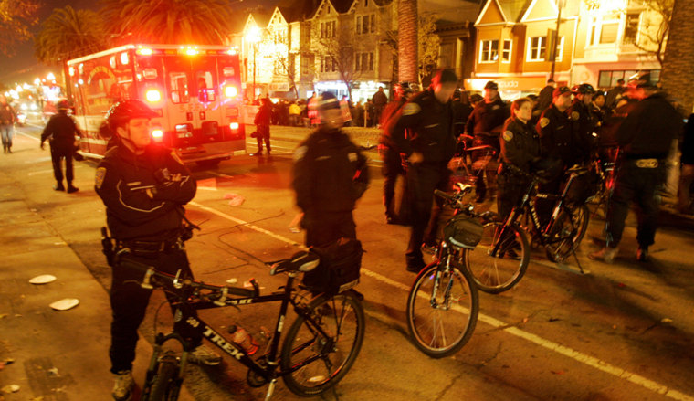 After reports of a multiple shooting on the 2200 block of Market St. in San Francisco Tuesday Oct. 31, 2006, police secure the area. Seven people were shot as a massive Halloween street party in the city's Castro district wound down Tuesday night, police said. The shootings occurred around 10:40 p.m., as authorities began dispersing thousands of revelers under a new curfew that was aimed at controlling the traditionally raucous event. (AP Photo/Michael Macor - San Francisco Chronicle)