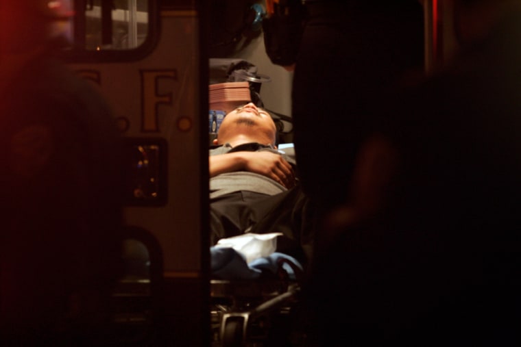 A man injured in a Halloween party shooting is tended to inside an ambulance in San Francisco on Tuesday night.