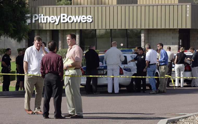 Phoenix police investigators gather Thursday outside a Pitney Bowes office where two employees were shot Thursday, Nov. 2, 2006, in Phoenix. Police said they have arrested a suspect. 