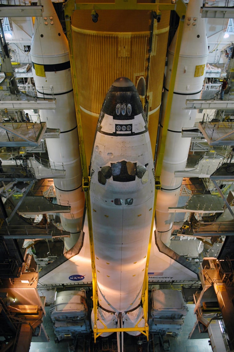 The orbiter Discovery is settled into place behind the external tank and solid rocket boosters in the Vehicle Assembly Building at NASA's Kennedy Space Center in Florida.  Discovery is scheduled to roll out to Launch Pad 39B no earlier than Nov. 7 for its December mission.