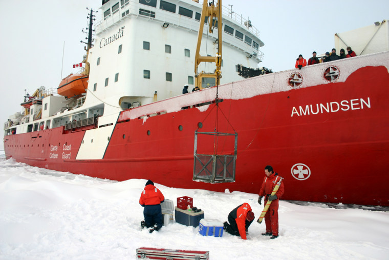Researchers take samples of the ice from an iceflow beside the Amundsen ship in the Northwest Passage.