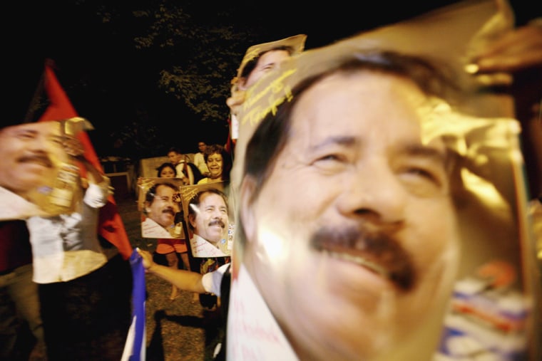 Sandinista Front supporters hold pictures of Ortega during celebrations in Managua