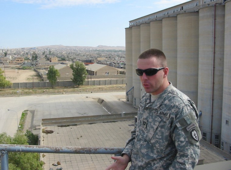Capt. Mike Lingenfelter, 32, of Panhandle, Texas, stands atop a large granary in Tall Afar, Iraq, a city where U.S. troops have been working to transfer control to Iraqi security forces. Lingenfelter, commander of Comanche Troop, 3rd Squadron, 4th Cavalry Regiment, said it would be "an extreme betrayal" to leave Iraq now.
