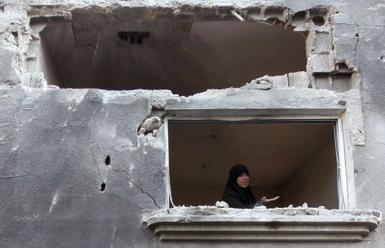 A Palestinian woman cries inside her damaged house following Israeli shelling at Beit Hanoun town in the northern Gaza Strip
