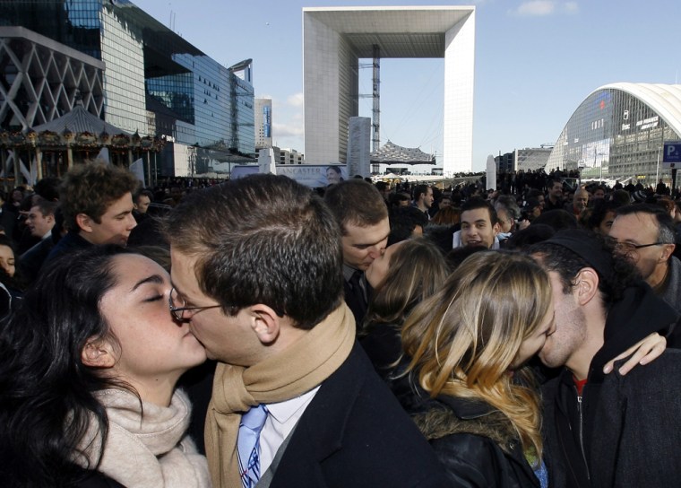 Participants simultaneously kiss to gain entry into the Guinness World Records during Guinness World Records Day at La Defense near Paris
