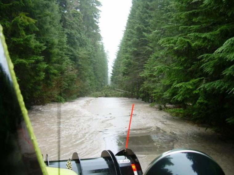Floods caused the White River to flow over SR410.