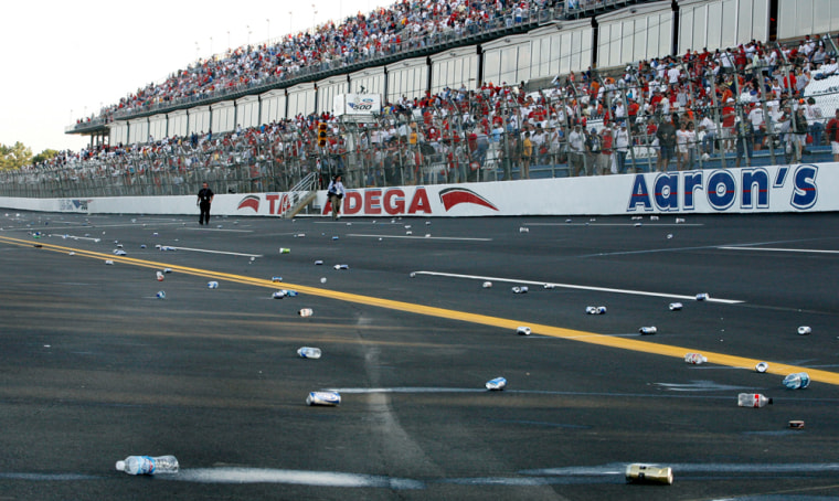 Debris litters the track after the NASCAR UAW-Ford 500 auto race, Sunday, Oct. 8, 2006, at Talladega Superspeedway in Talladega, Ala. Fans threw cans and bottles onto the track after a collision on the last lap involving Dale Earnhardt Jr., Jimmie Johnson and eventual race winner Brian Vickers. (AP Photo/Glenn Smith)