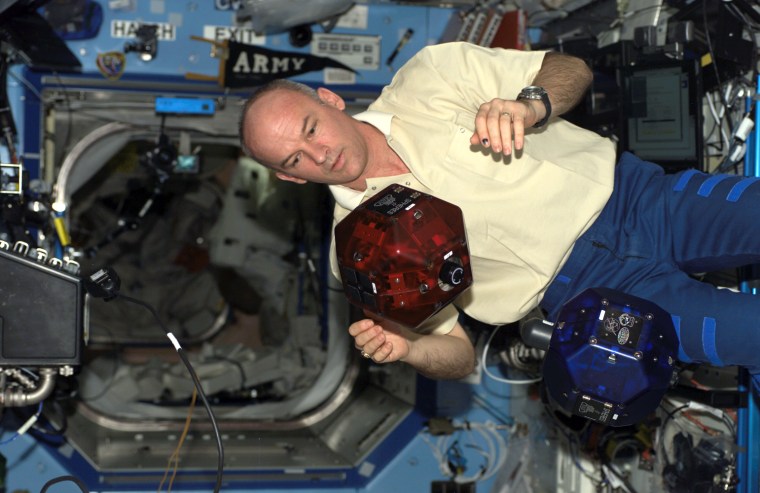Space station astronaut Jeff Williams conducts a check of a free-flying SPHERES satellite in August during his stint in orbit.