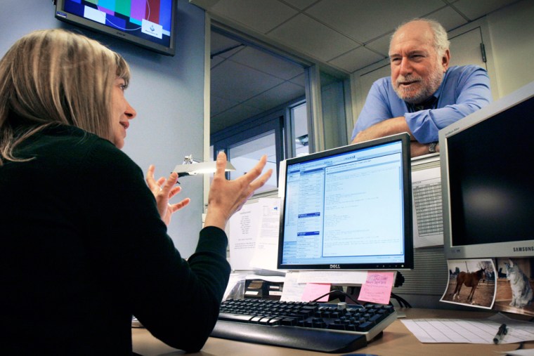 Dave Marash, longtime network newsman, is now in the anchor chair for Al Jazeera English. Pictured, Marash, right, chats with planning editor Nathalie Joost, left, in the Al Jazeera English newsroom.