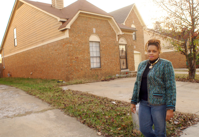 Church member Jean Phillips walks past the Memphis house at the center of the dispute.
